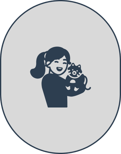 Smiling person holding a small dog.